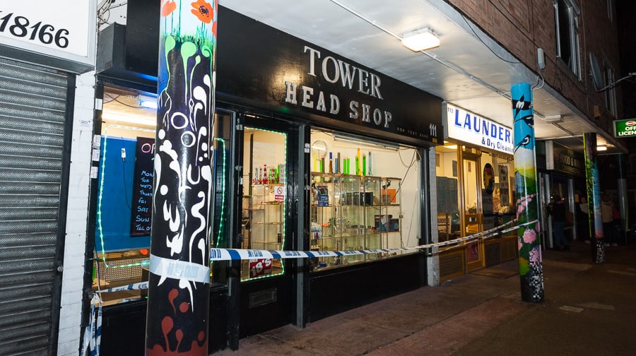 Two men burst into Tower Head Shop with a gun demanding money and escaped in a gold car