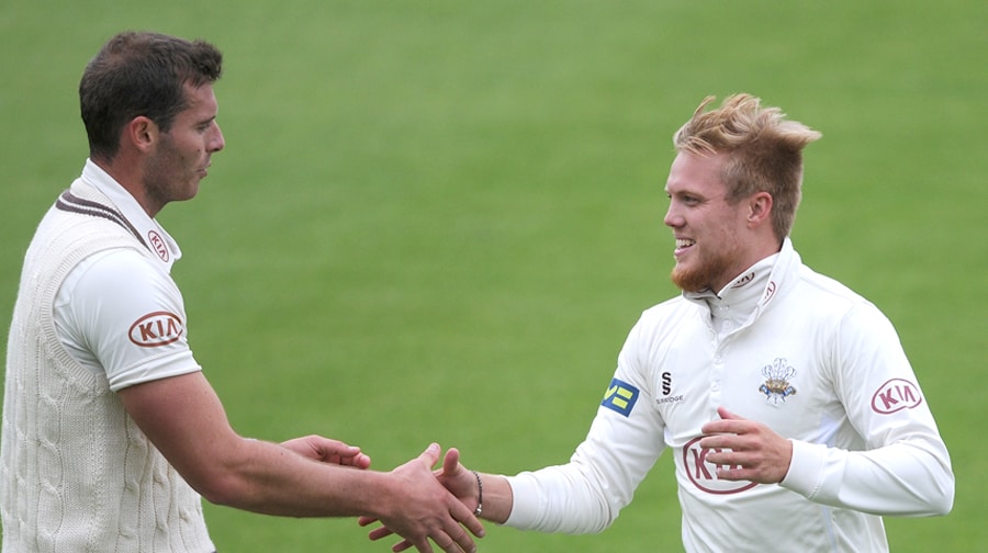 Surrey's Chris Tremlett (left) congratulates Matt Dunn after taking five Gloucestershire wickets in the first innings.
