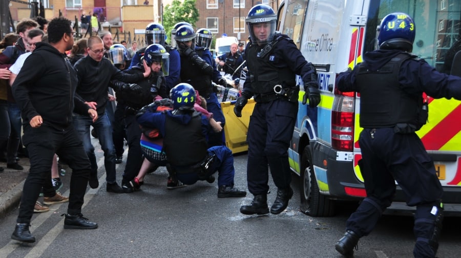 Officers in riot gear piled into East Street  on Sunday after an immigration van was pelted with eggs