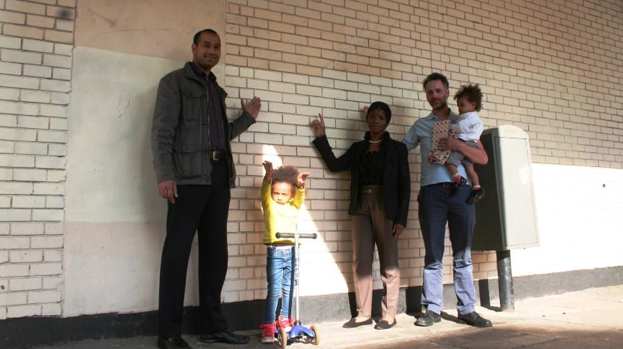 Joan Morris with Cllr Jamille Mohammed at the proposed peace wall with local resident  Thibaut Remy and his two daughters