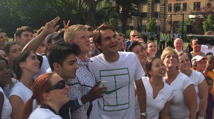Federer posing with fans.