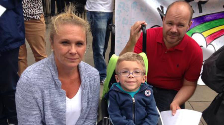 Harvey Brown with his mum and dad, Vikki and Dean, at the protest outside parliament. Pic: @Annareporting