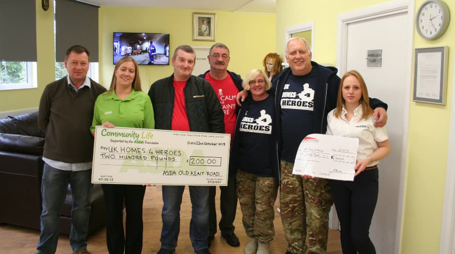Jimmy Jukes and Michelle Thorpe along with representatives from A&E Elkins, Asda, and other fundraisers.