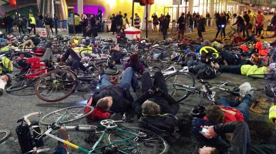Cyclists lie across the road in the protest. Photo: Andrew Reeves-Hall