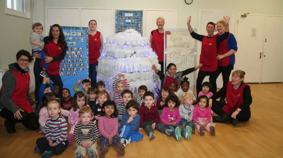 Trinity Childcare staff and children with their creation