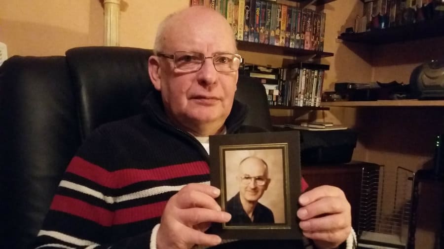 Keith Buxton holds photo of his late fiancé David Newman
