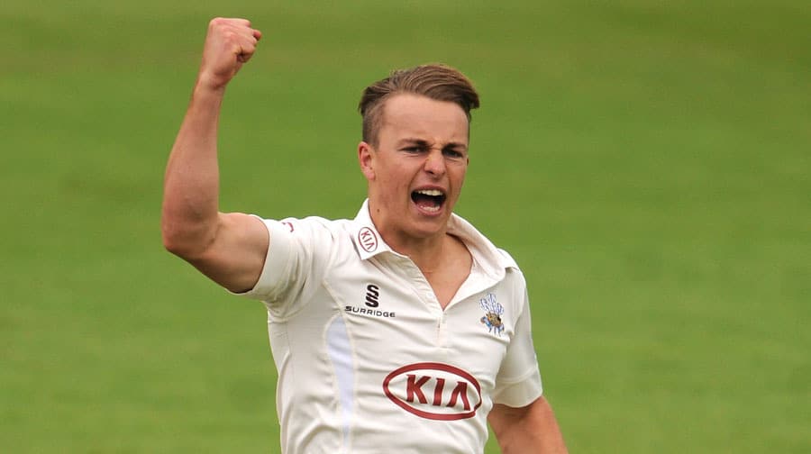 Surrey's Tom Curran celebrates after taking the wicket of Gloucestershire's Benny Howell.