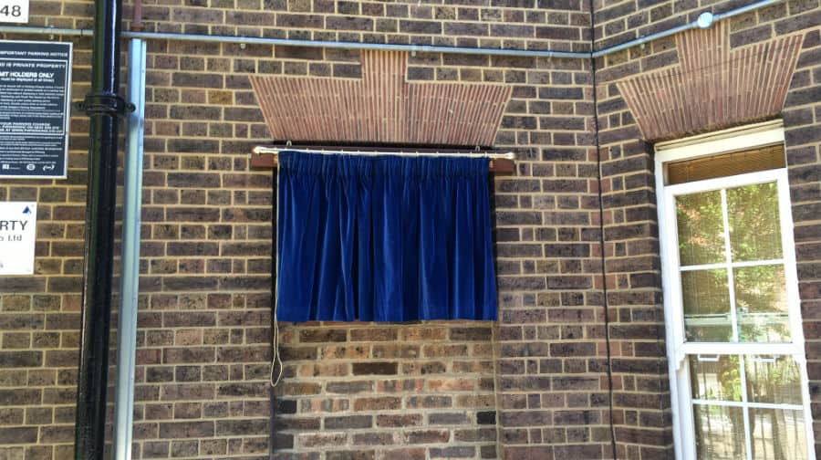 A blue plaque waiting to be unveiled