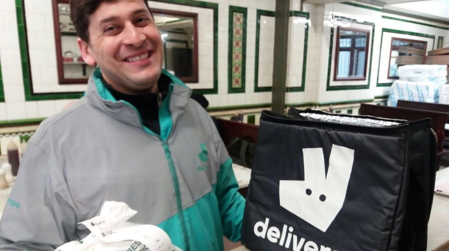 A Deliveroo rider picks up a Manze's order in Tower Bridge Road