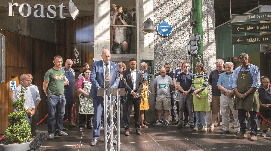 Borough Market traders bow their heads during a minute's silence in memory of the London Bridge terror attack victims in 2017 (Credit: Christian Fisher)