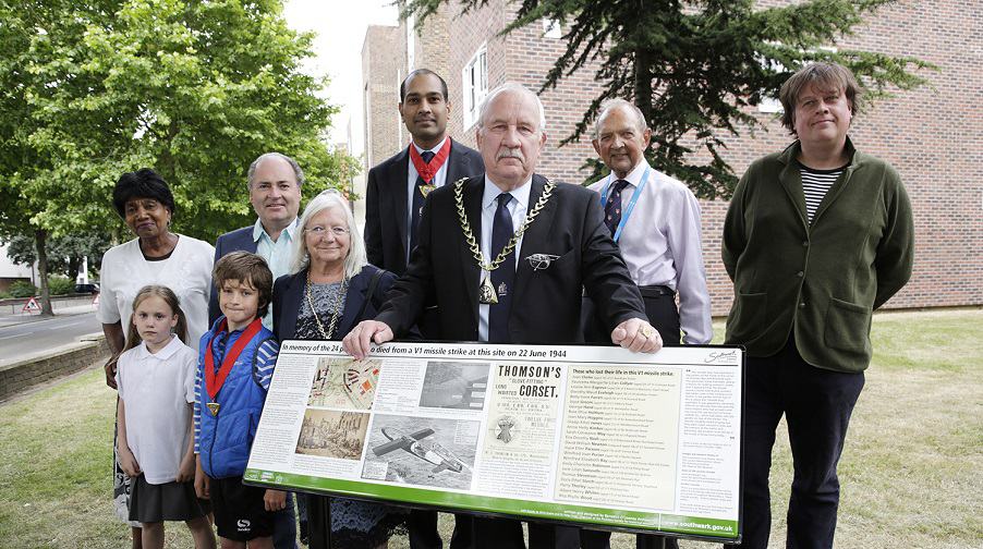 Mayor Charlie Smith unveils board to commemorate Corset Factory bombing. Back row: Cllr Ian Wingfield, deputy mayor Jamille Mohammed; Dr Peter Frost and Bennedict O'Looney