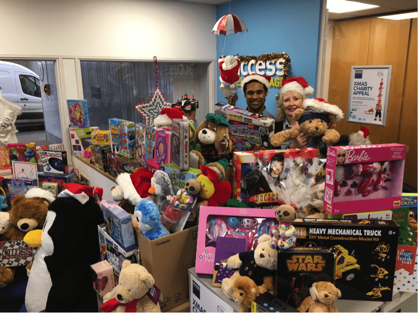 Gifts collected in 2016 Access Self Storage Christmas appeal, with team members Julian Hamilton and Deslynn Barter