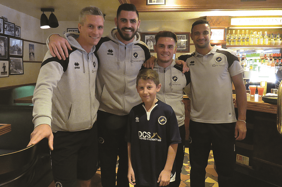 Millwall players Steve Morison, Tom King, Ben Thompson, and James Meredith with a young fan