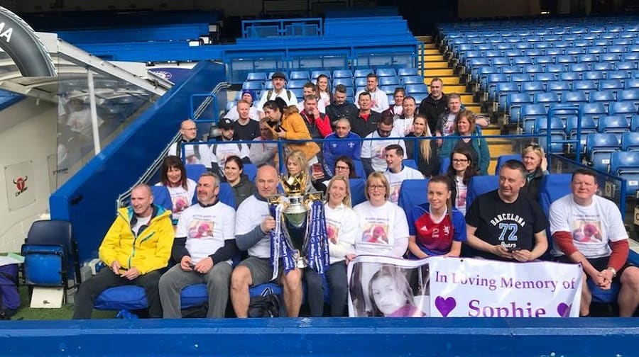 The group pose for a photo with the Premier League trophy at Chelsea Football Club