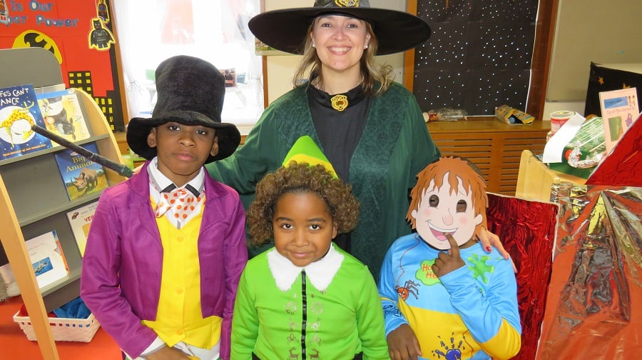 Ark Globe Academy primary principal Ms Colburn with pupils dressed up for World Book Day 2018