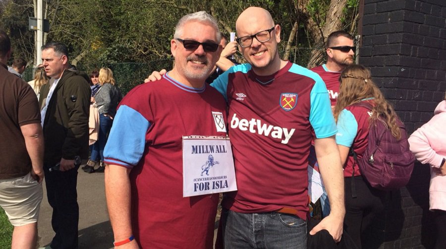 Millwall fans Nick Hart (left) and Bill Slack wore West Ham shirts for a ten-mile sponsored walk alongside Hammers fans for a young cancer sufferer