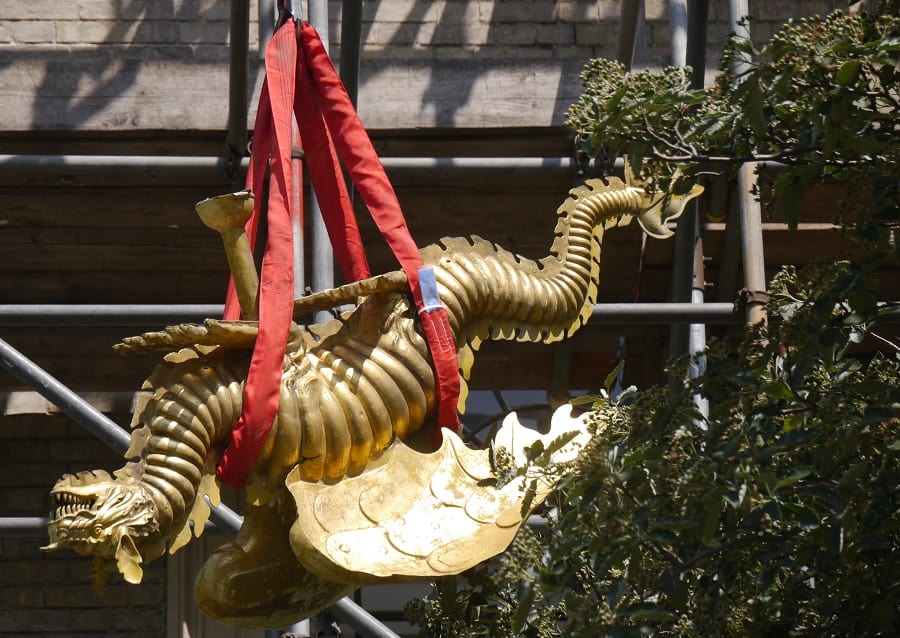 The golden dragon weather vane is brought down from the top of St James' Church, in Bermondsey, for repair work (Sandra Price)