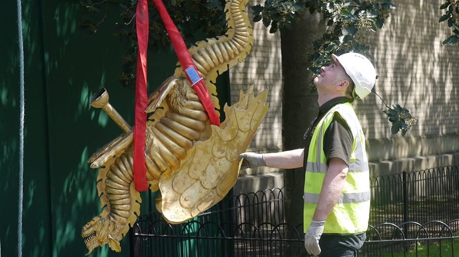 The golden dragon weather vane is brought down from the top of St James' Church, in Bermondsey, for repair work (Sandra Price)