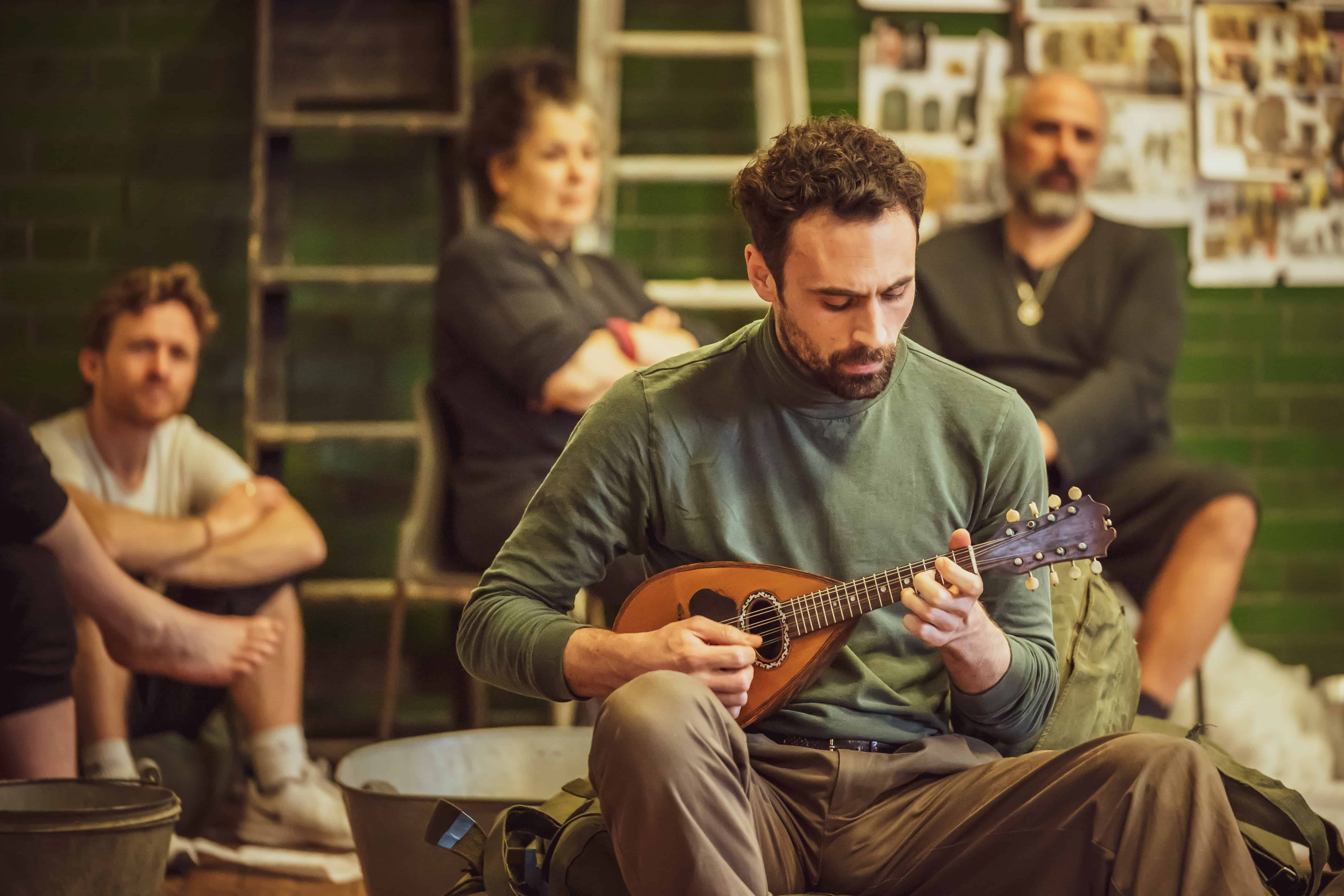 Alex Mugnaioni in rehearsals for Captain Corelli's Mandolin with the missing instrument. Credit Marc Brenner