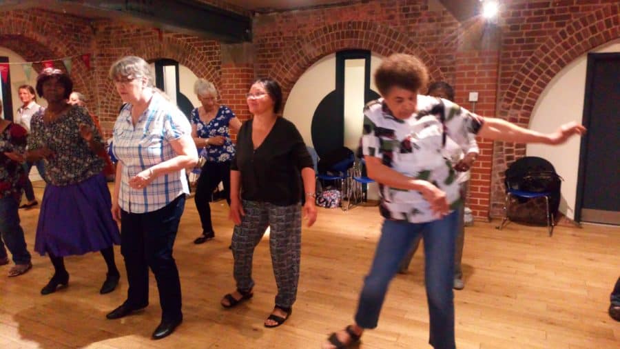 Dancers learn salsa at a previous First Time for Everything class