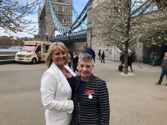 Irene (right) pictured outside the Tower of London where she got her medal