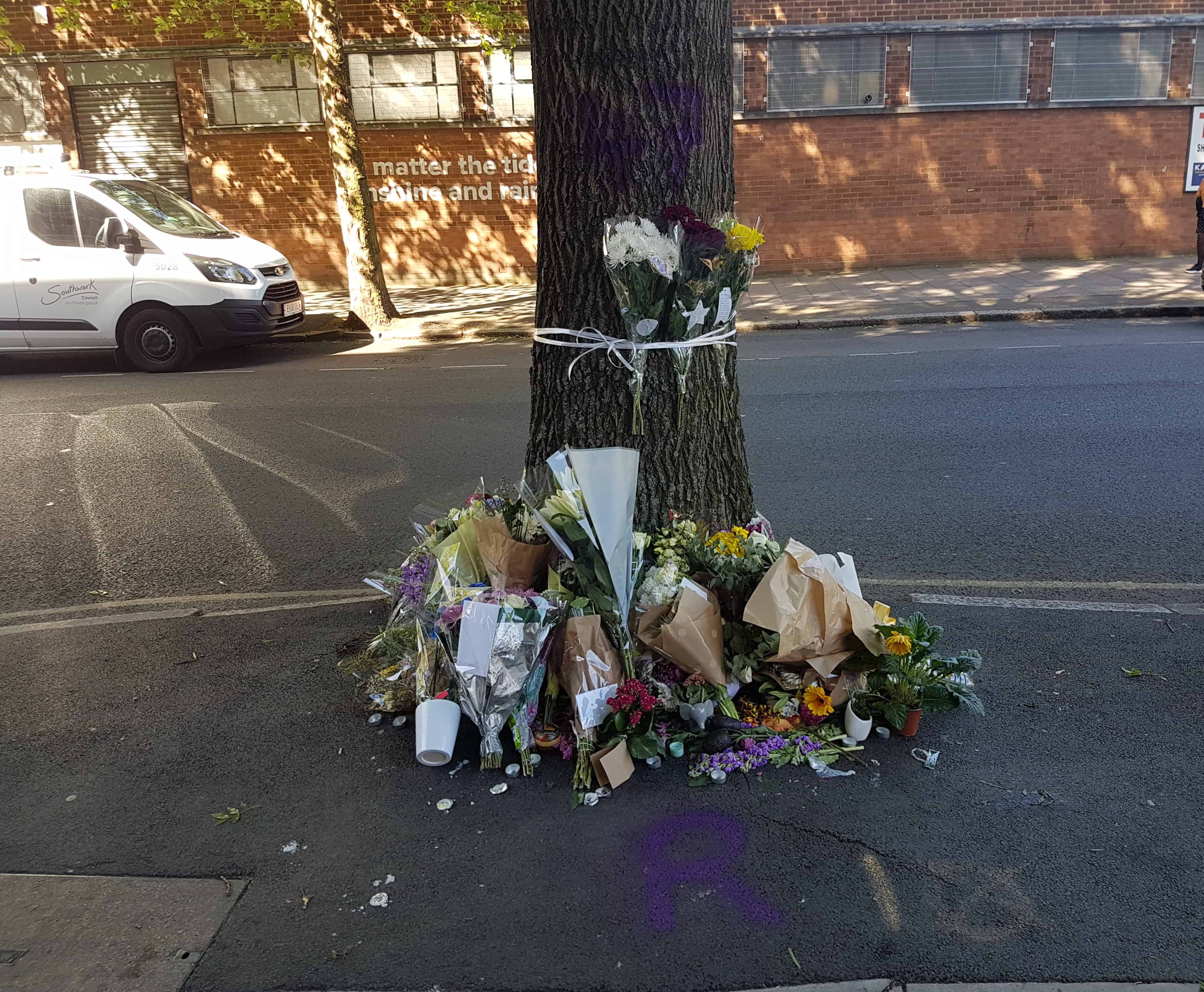 Flowers, cards and candles have been left at the scene where the man was found on Friday morning