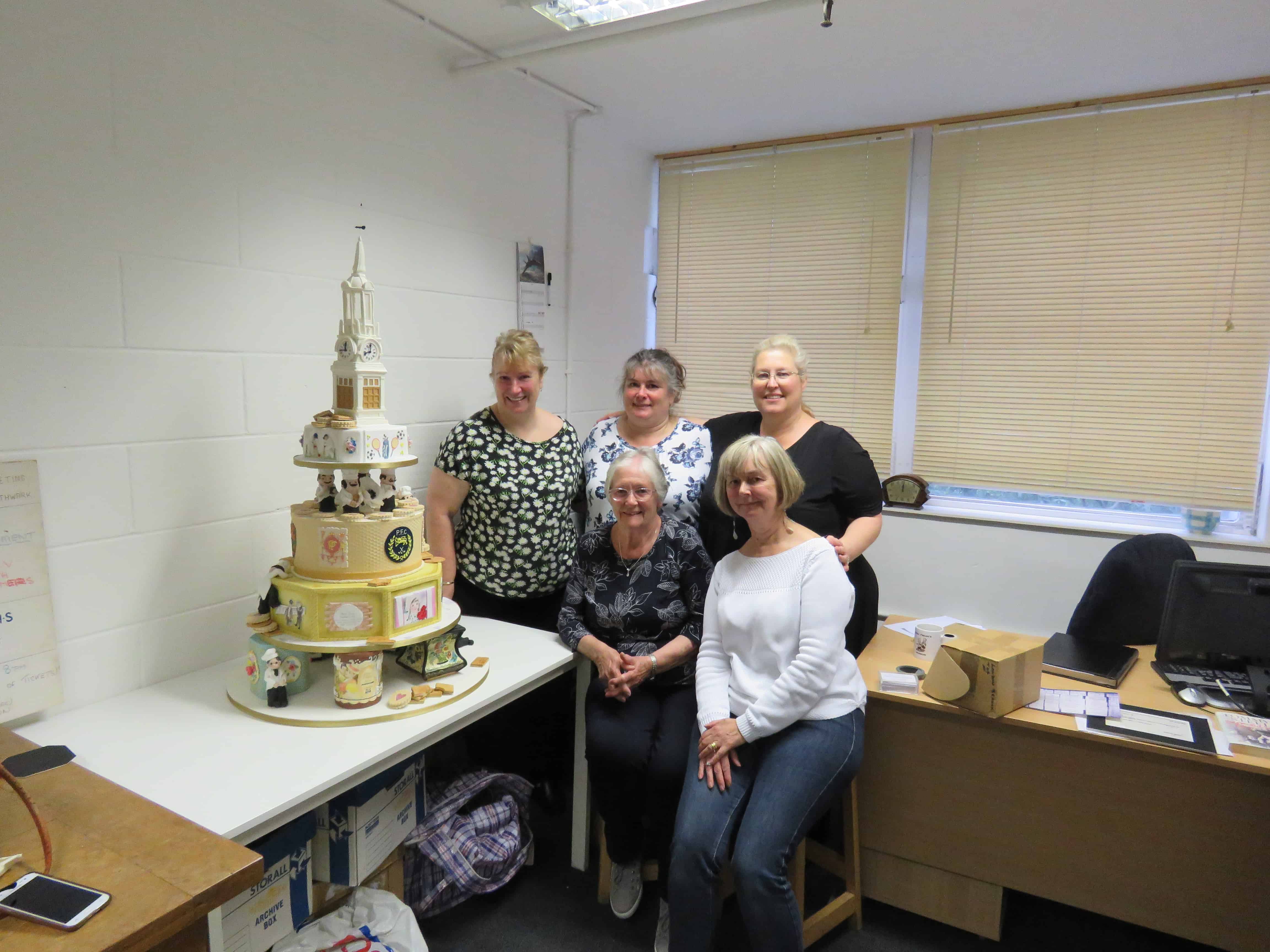The cake, pictured alongside members of the British Guild of Sugarcraft who created it