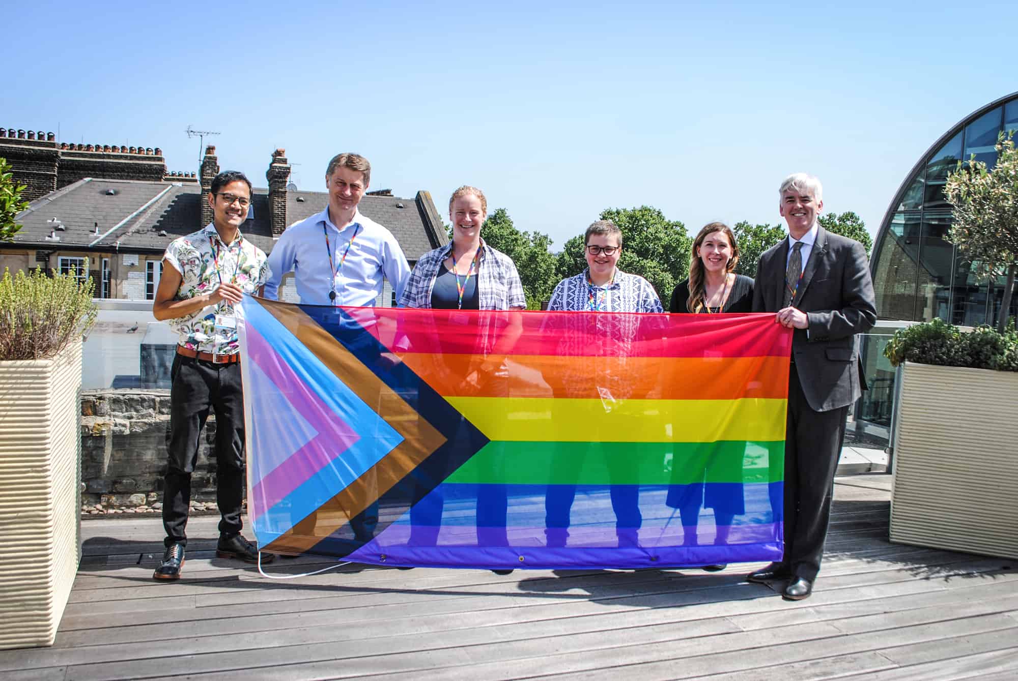 Members of the council's LGBT staff network flying the updated rainbow flag