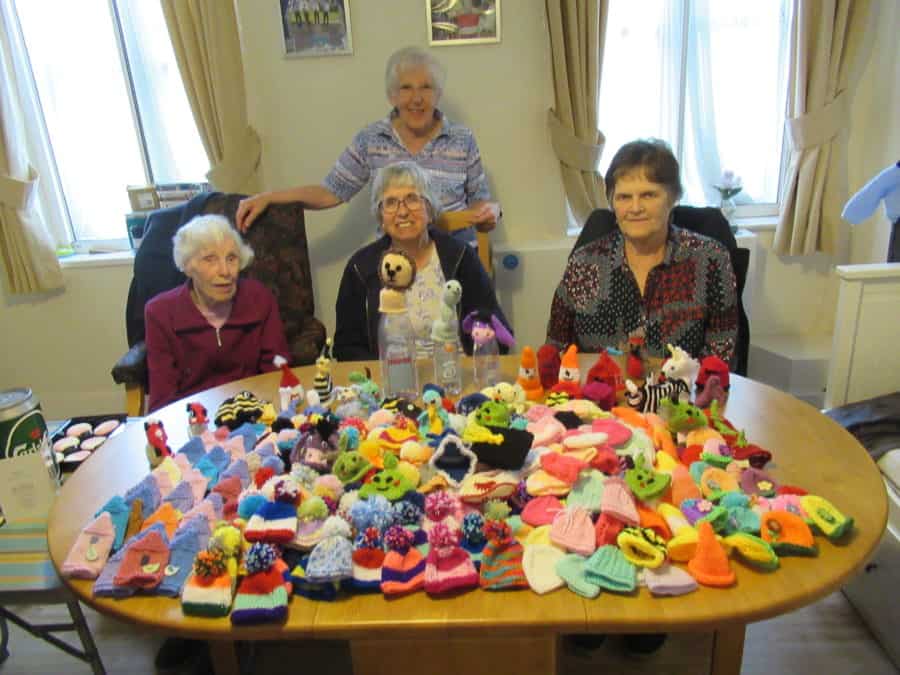 Members of the Dulwich Almshouse Charity’s knitting group Sheila Grantham, Freda Neville, Gwen Hickman (standing), and Doreen Medina, with their 250 knitted hats