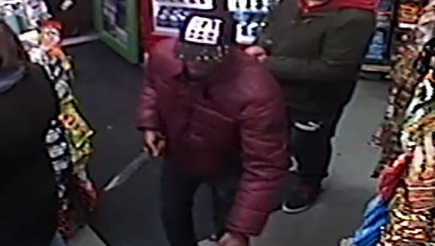 Riley, pictured on the shop's CCTV with the large hunting knife, moments before he murdered Dennis Anderson