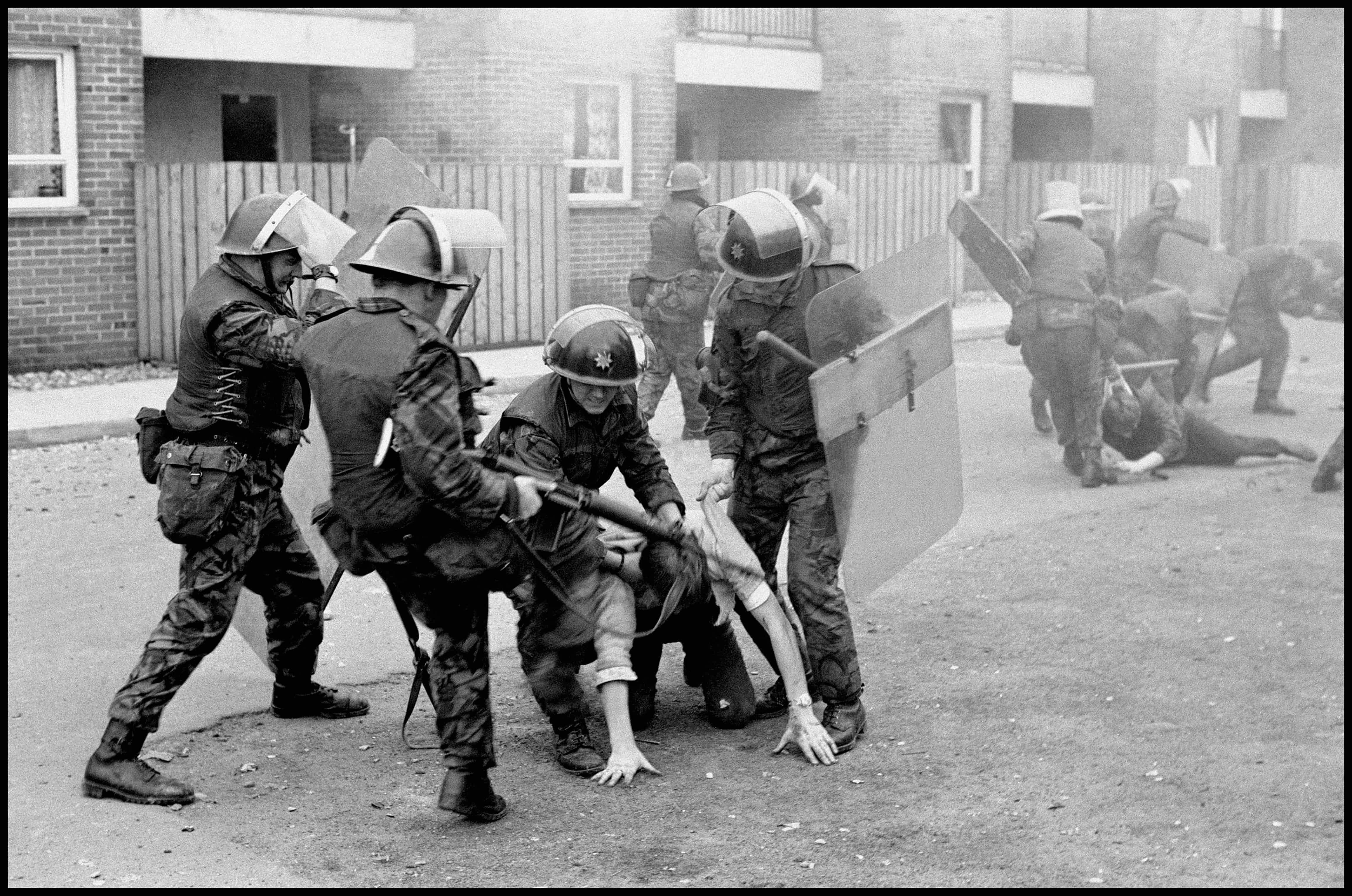 British soldiers drag ringleaders from a rock-throwing group and beat them severely. 1971. (c) Ian Berry