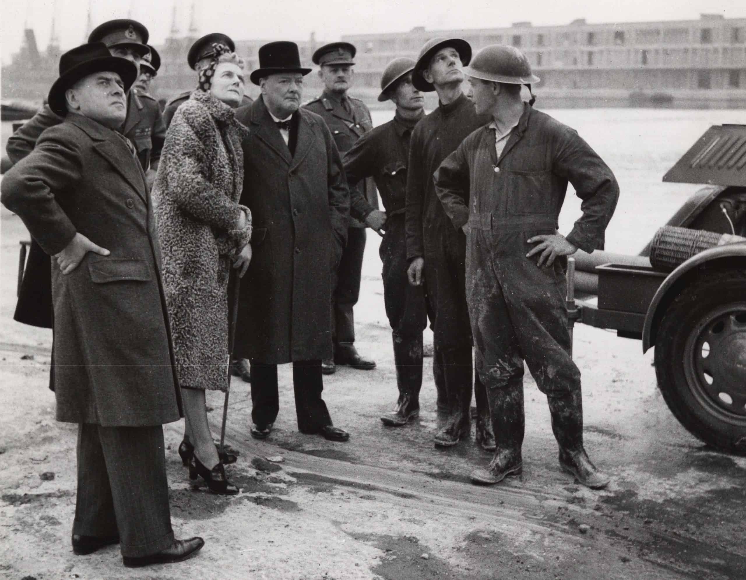 The Prime Minister and Mrs Churchill, with the Flag Officer, London, and J Douglas Ritchie (on left), touring London's dock in Sept 1940, seen with a group of auxiliary firemen