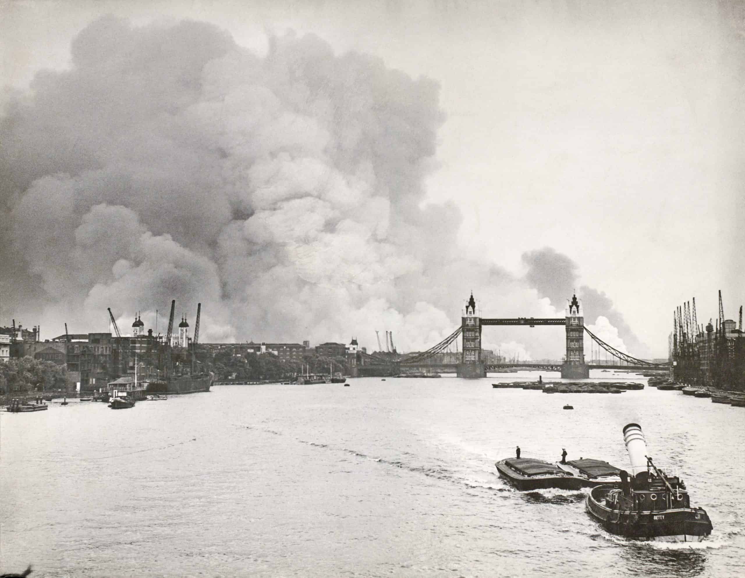 The Docklands ablaze during the Blitz on 7th September 1940. The rising palls of smoke mark out the London Docks beyond the Tower of London, the Surrey Docks to the right of the bridge and the West India Docks on the Isle of Dogs in the distance.
This image can be found on page 36 of the book London's Changing Riverscape.