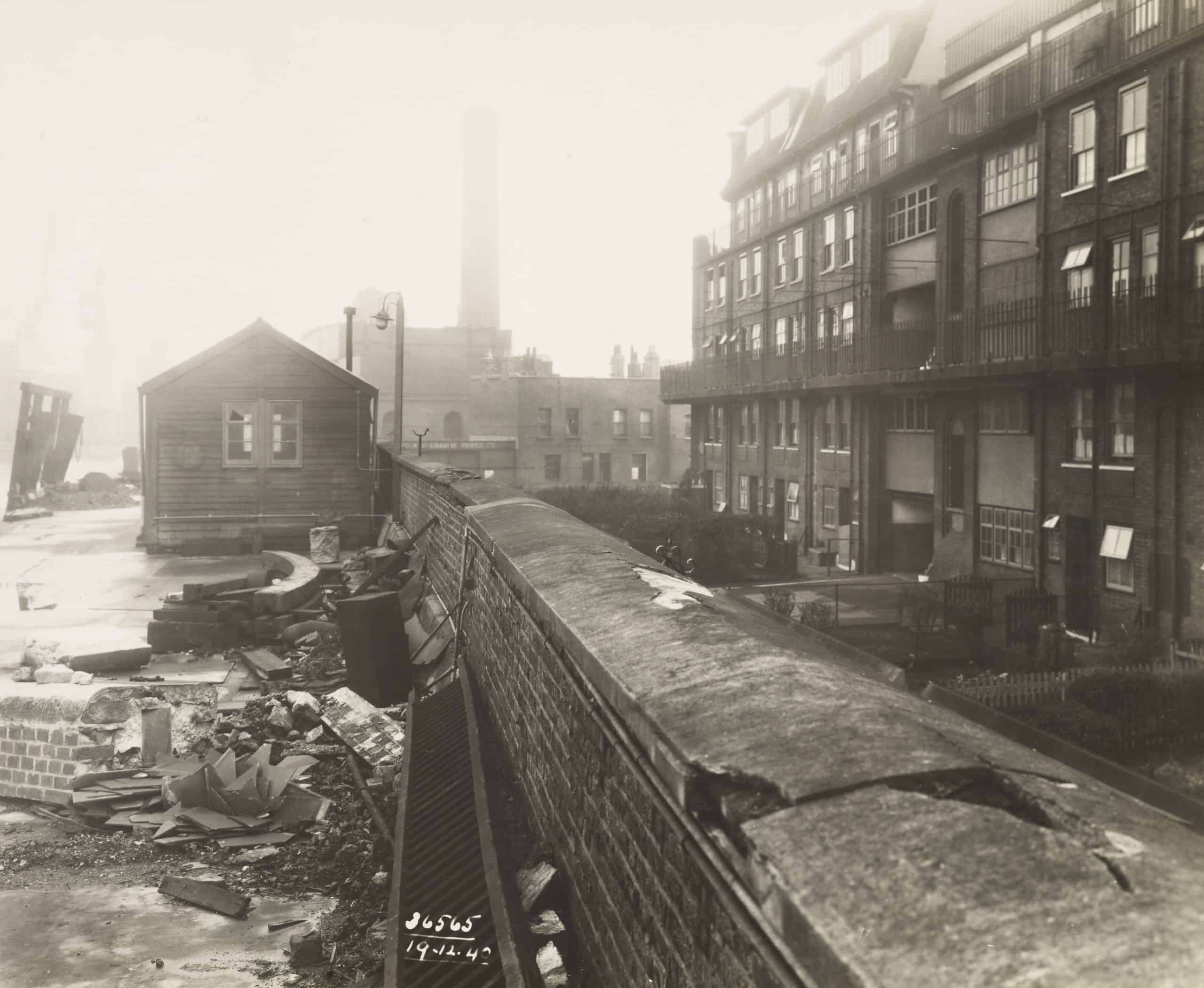 WWII Bomb damage to London Dock. Milk Yard Boundary Wall. South side of Shadwell Old Basin, looking east.
Date of air raid 8-9/12/1940
Date: 19/12/1940