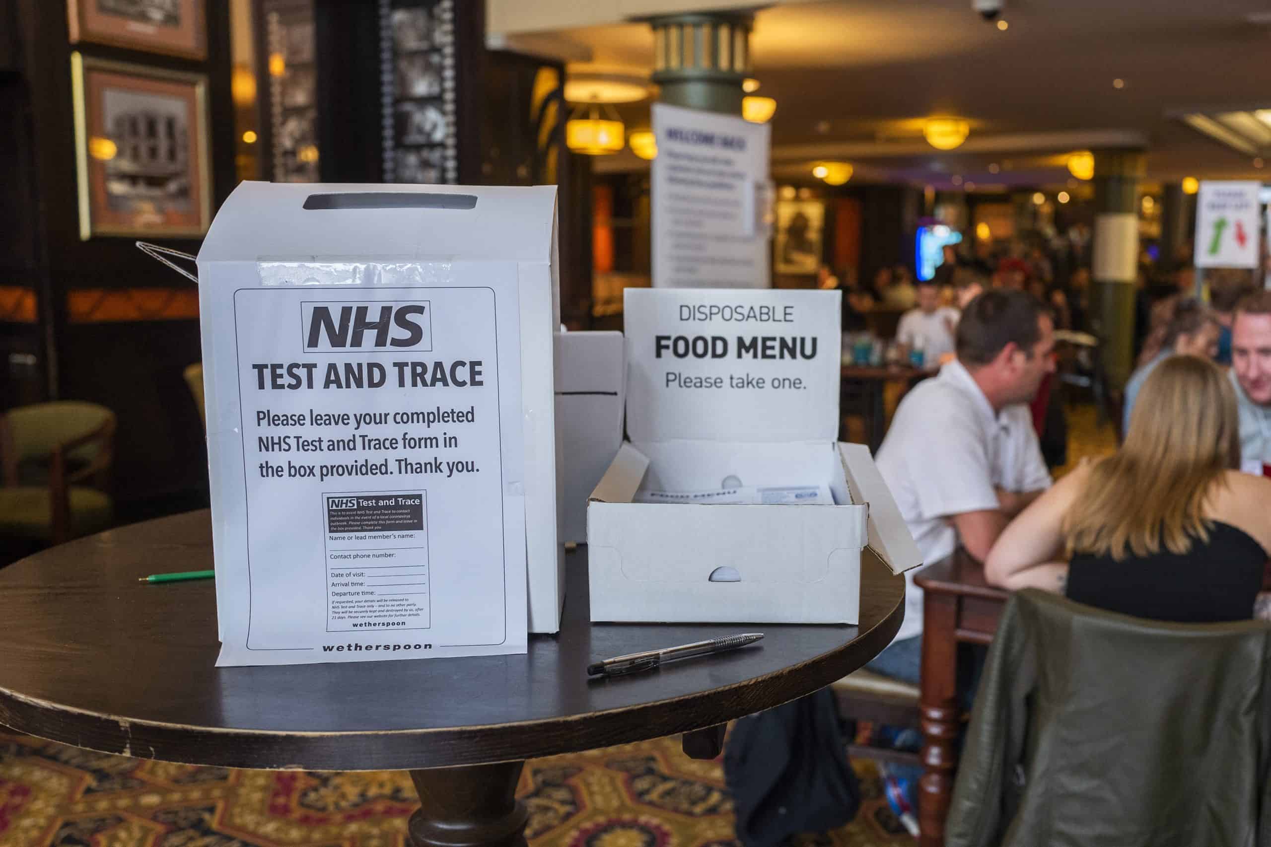 Image: An NHS Test and Trace box in a pub