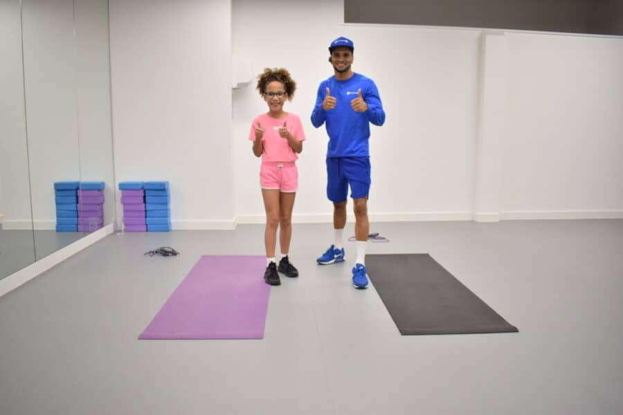 Amelia helping Shane out in his latest workout video