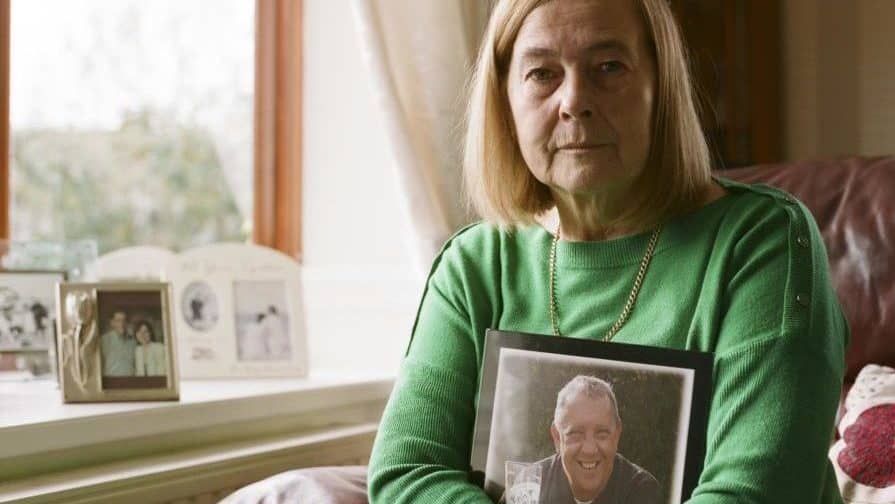 Gill with a picture of her late husband, David, who died from COVID-19 complications