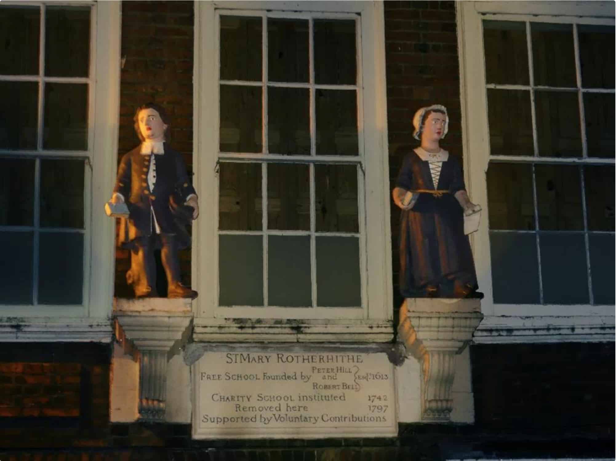The two figurines on the Old Schoolhouse building opposite St Mary's Church, Rotherhithe