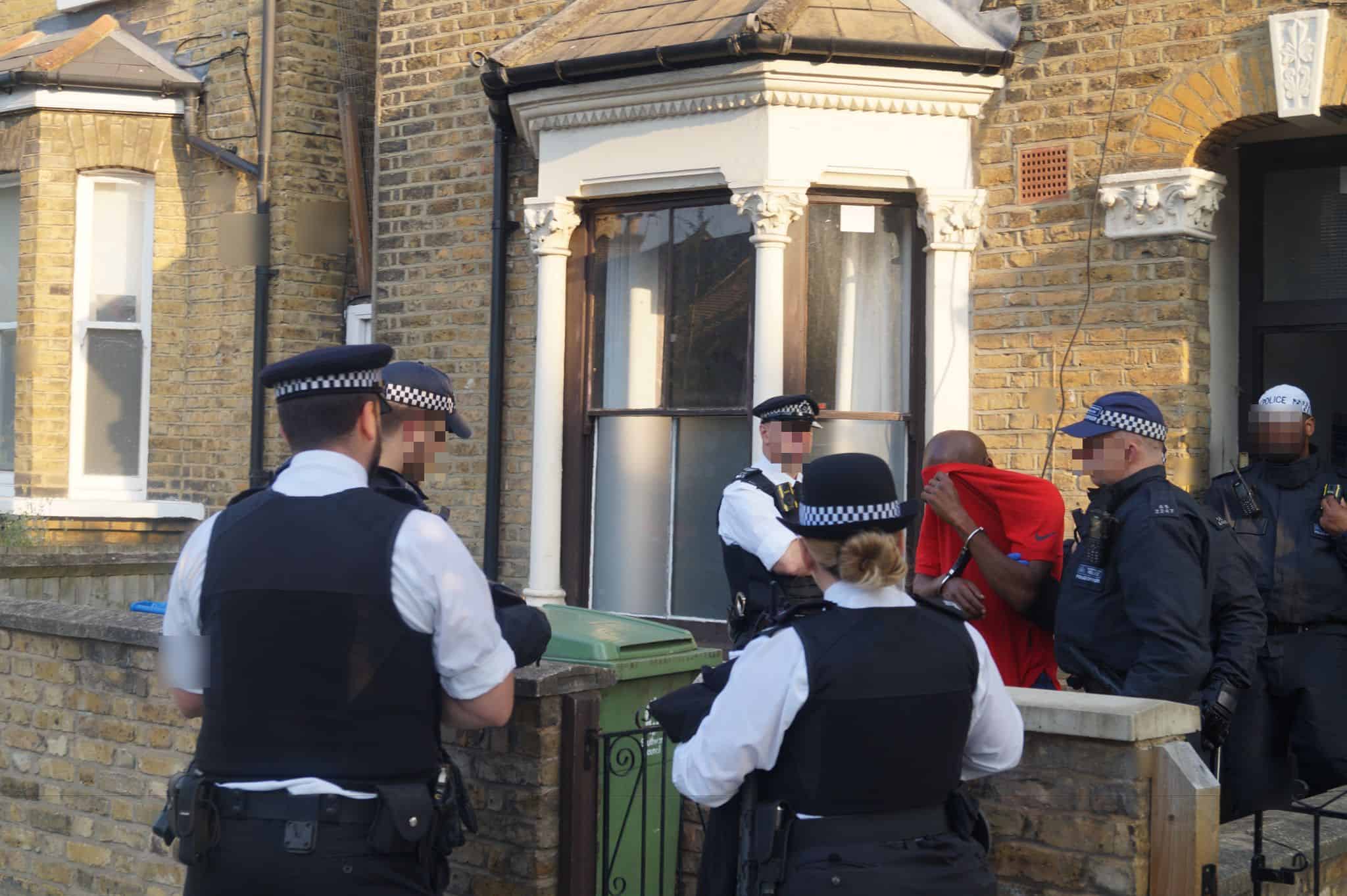 One of the suspects being arrested in Peckham