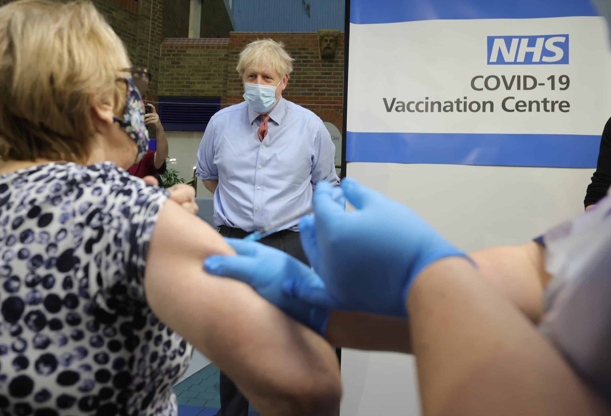 08/12/2020. London, United Kingdom. Boris Johnson visits Covid-19 Vaccine Centre. The Prime Minister watched Lynn have her Covid-19 Vaccine injection at Guy's Hospital in central London, on the day the vaccine was rolled out across the country. Picture by Andrew Parsons / No 10 Downing Street