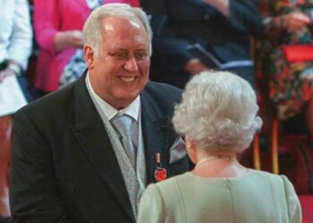 Jimmy Jukes getting his MBE from the Queen