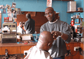 Lloyd in one of his barber shops doing what he did best