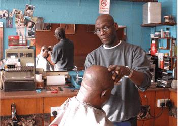 Lloyd in one of his barber shops doing what he did best