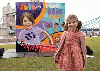 GOSH patient Sienna with completed TCS London Marathon mural featuring her portrait.