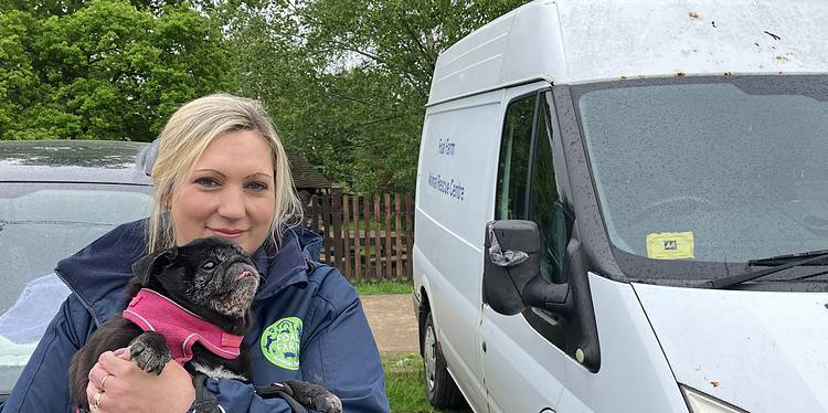 Lucy Bennett, finance manager for Foal Farm, shown with Bug the pug in front of the farm's current animal ambulance. Photo by  Joe Coughlan.