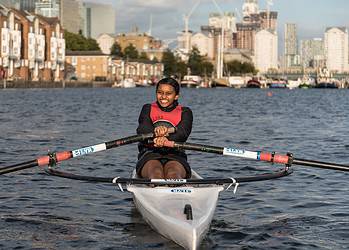 A girl rowing at Canada Water Dock