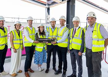 Contractors celebrate the building's topping out