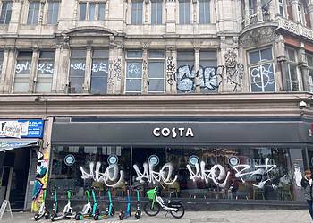 Graffiti covering the window panes of Peckham's Costa Coffee. Photo by Robert Firth