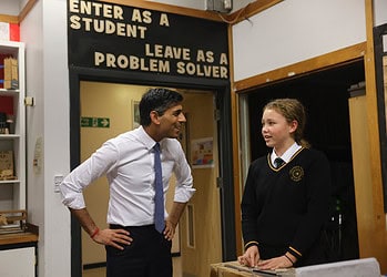 (pictured: Prime Minister Rishi Sunak with a student in school uniform)