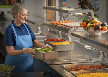 Stock image of dinner lady preparing school lunches. Credit: U.S Department of Agriculture (Creative Commons)